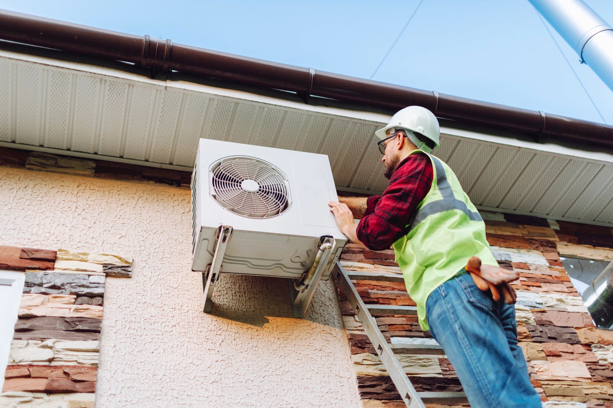 Homeowner inspecting air conditioner